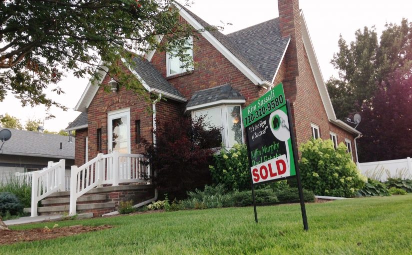 house with a sign saying sold