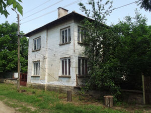 Old country house with barn and land in a village near river