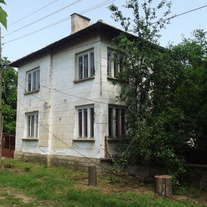 Old country house with barn and land in a village near river