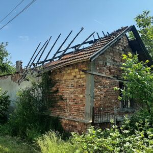 Plot of land with an old damaged rural house close to forest