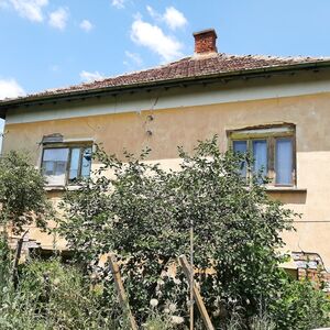 Old rural house with barn and land located in a big village